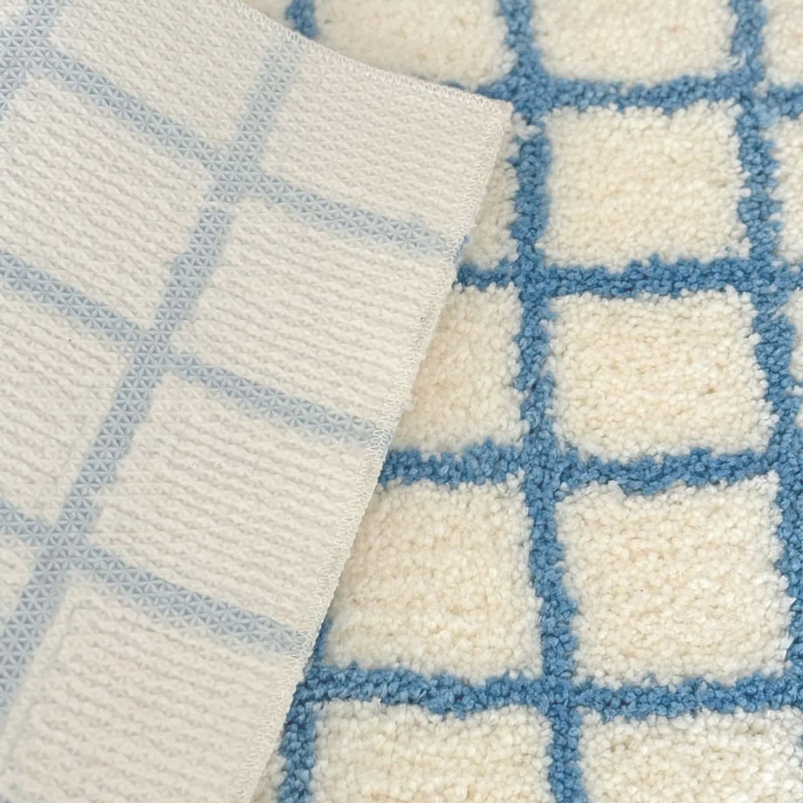 Close Up of Tufted Texture and Anti-Slip Dot Backing of Blue Checkered Rug - RoomDen