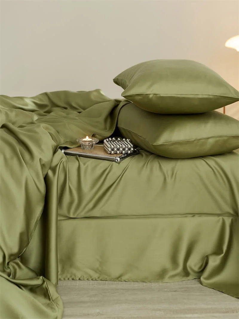 Close-up of the silky, lustrous texture of the olive green Cooling Tencel duvet cover and pillows - RoomDen.
