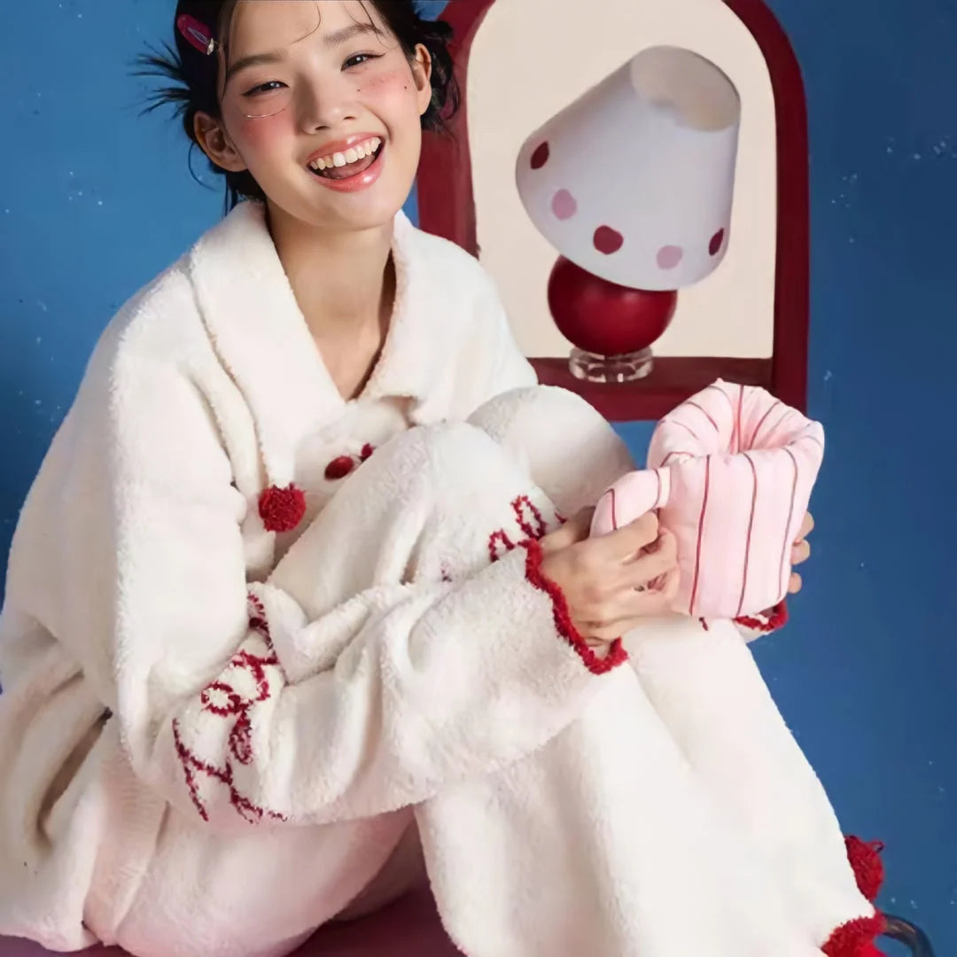 Lifestyle image of the model in the Cream White fleece pajama set, looking cozy and relaxed.