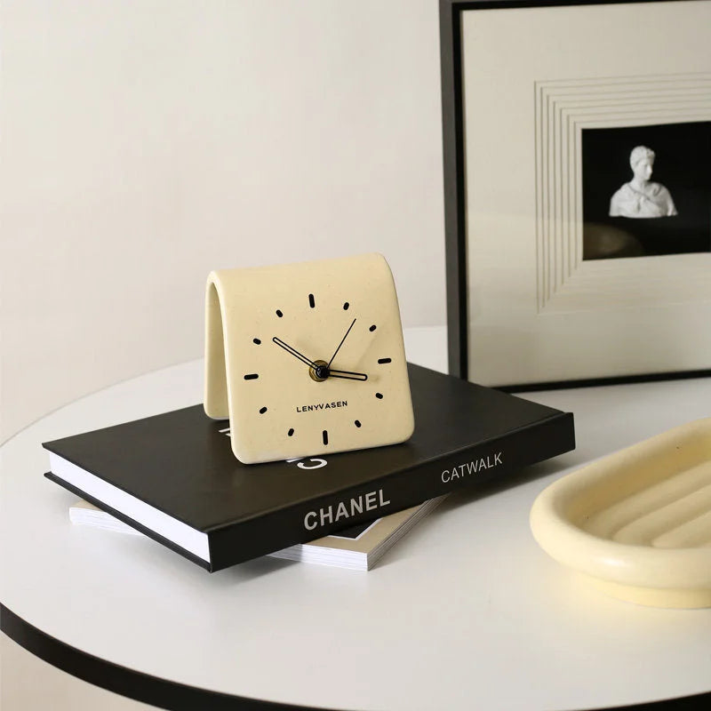 Butter Yellow Matte Arch Ceramic Table Clock styled on a black CHANEL book on a white table - RoomDen