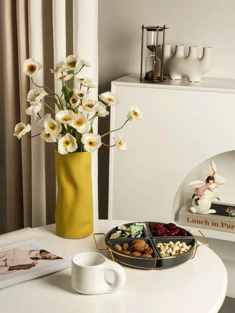 The Lemon yellow Ruched Ceramic Vase styled in a bright, modern living room with white poppies on a coffee table - RoomDen.