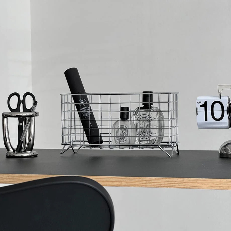 Close-up of the chrome silver metal organizer with beauty products on a minimalist desk. - RoomDen