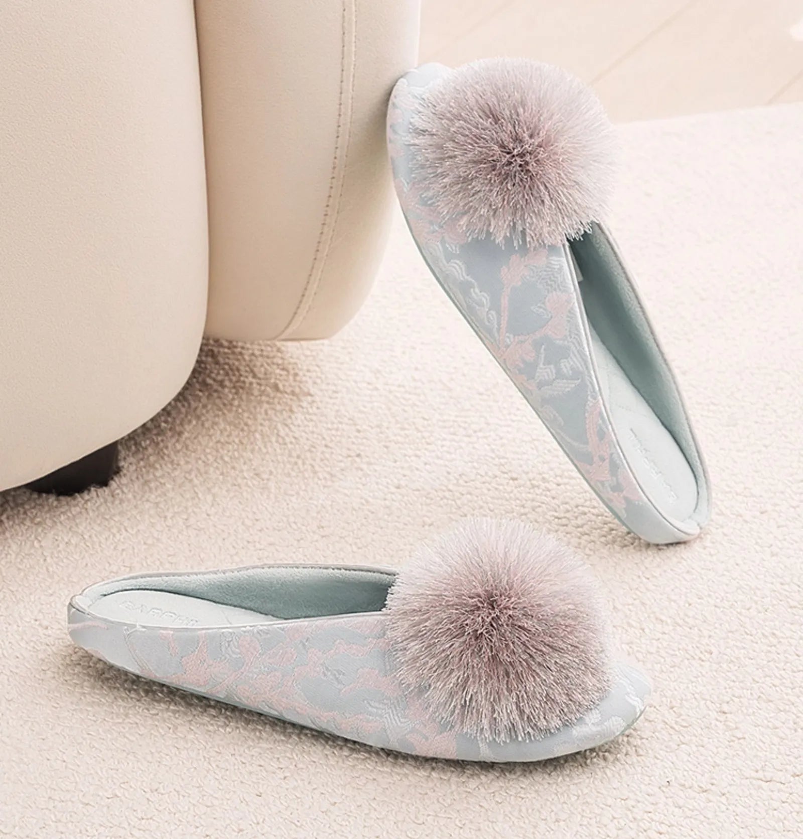 Top down view of blue floral jacquard slippers on carpet - RoomDen