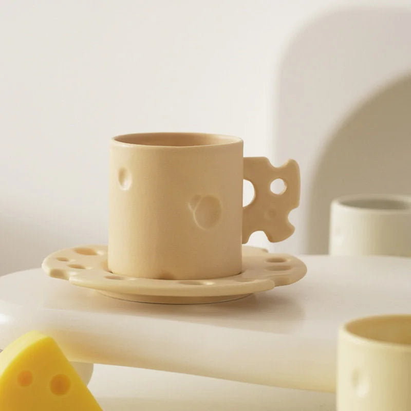 Close-up of the yellow Cheese Ceramic Mug & Saucer Set showing its textured details. - RoomDen