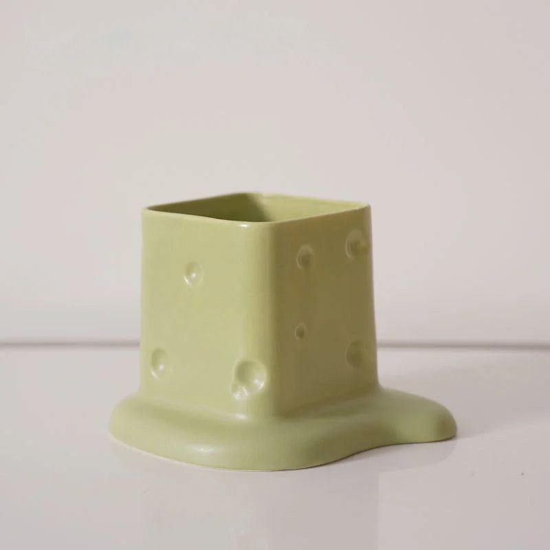Close-up of the Pistachio Green melting cheese ceramic desktop organizer on a white background. - RoomDen