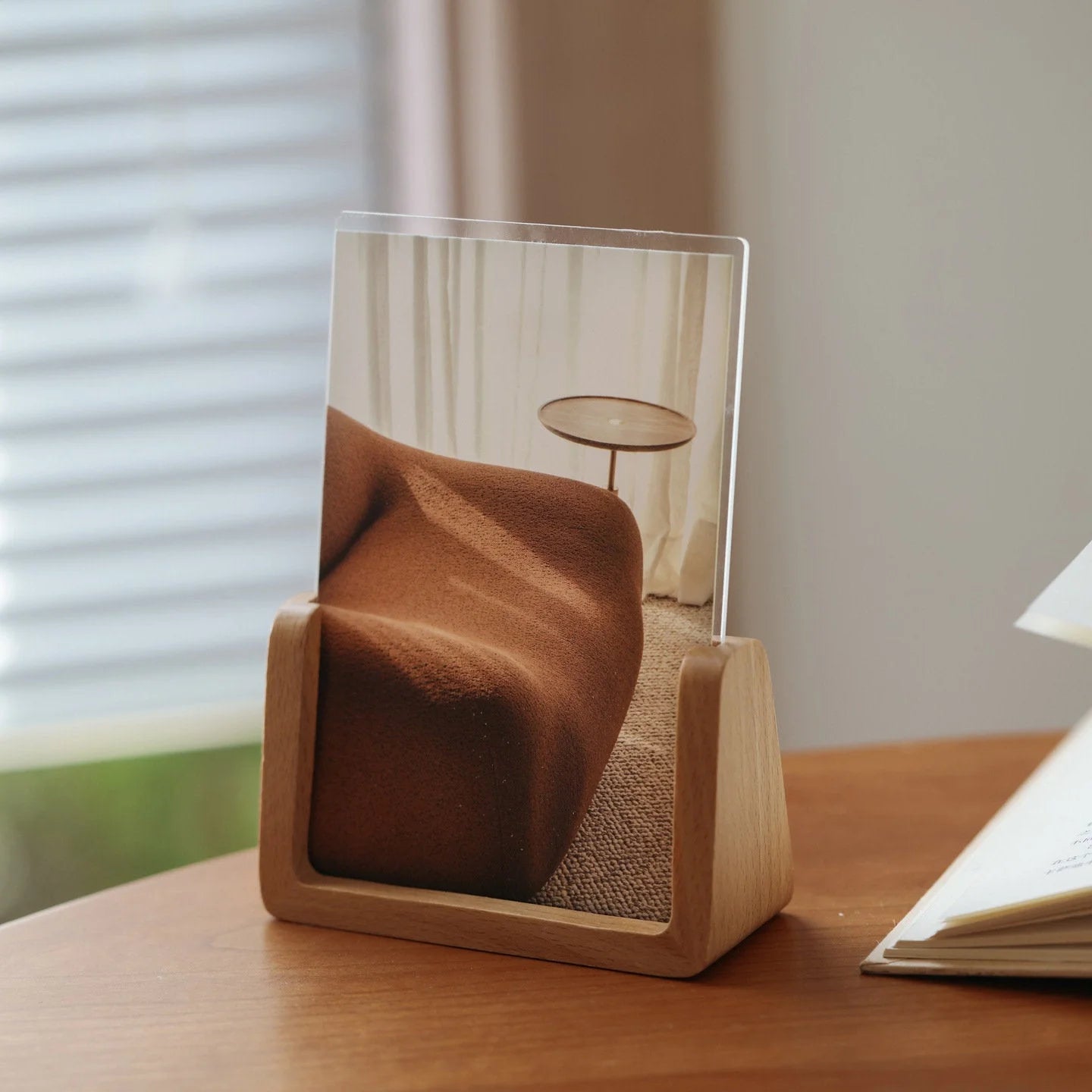 Close-up of a single photo from the wall collage kit placed in a wooden stand on a desk. - RoomDen