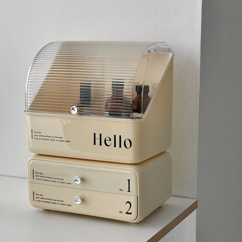 Front view of the 'Hello' typographic stackable makeup organizer in a cream beige color. - RoomDen