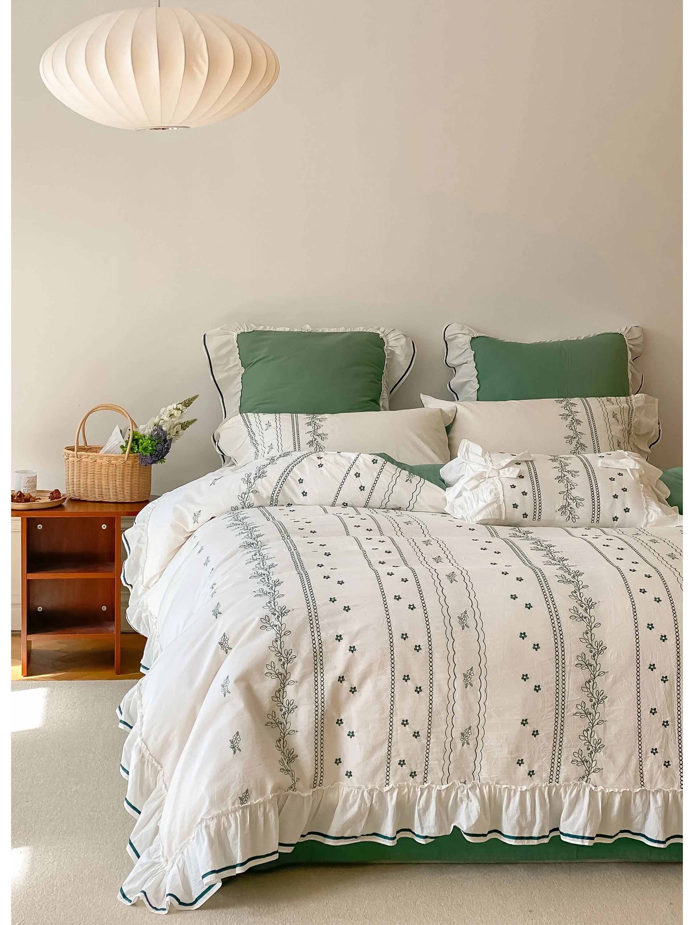 Ruffled Floral Vine Embroidered Cotton Bedding Set in Forest Green, shown on a bed with a modern pendant light. - RoomDen