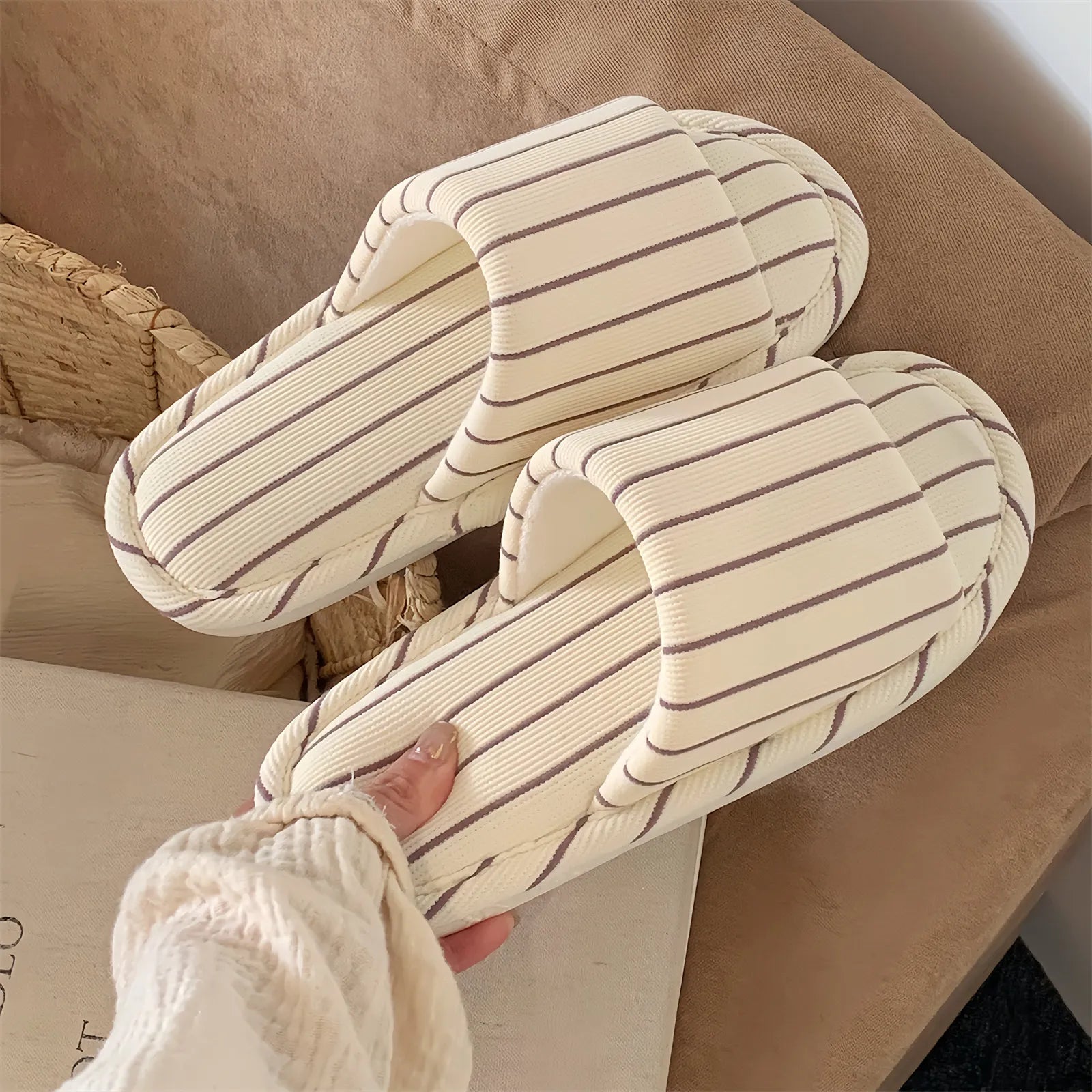 A pair of Beige & Brown Striped slippers resting on a soft beige surface, emphasizing the warm neutral tones.