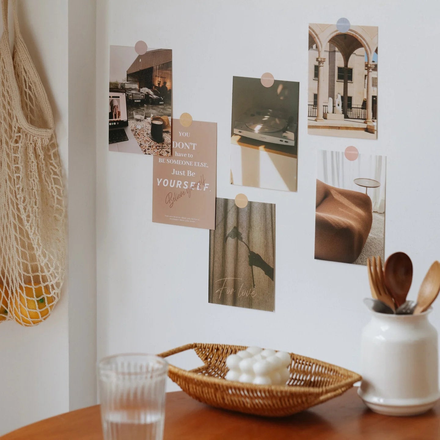 Aesthetic wall collage kit displayed in a cozy room setting with a woven bag and ceramic vase. - RoomDen