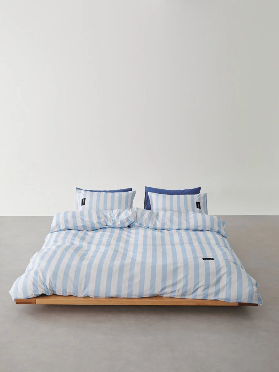 Front view of Sky Blue & White Striped Bedding Set on low profile bed - RoomDen