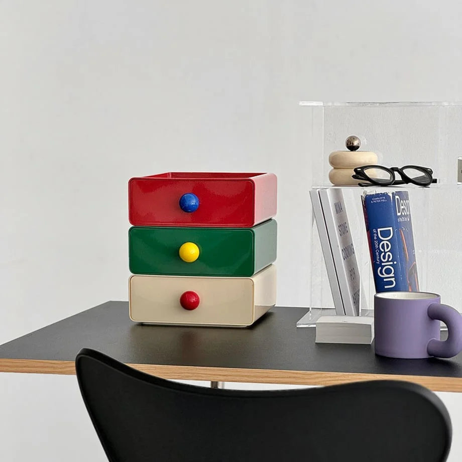The tricolor stackable desk organizer next to a clear acrylic file holder and a purple mug. - RoomDen