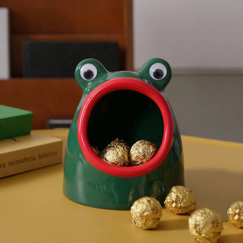 Close-up of the green and red frog ceramic bowl filled with gold-wrapped chocolates. - RoomDen
