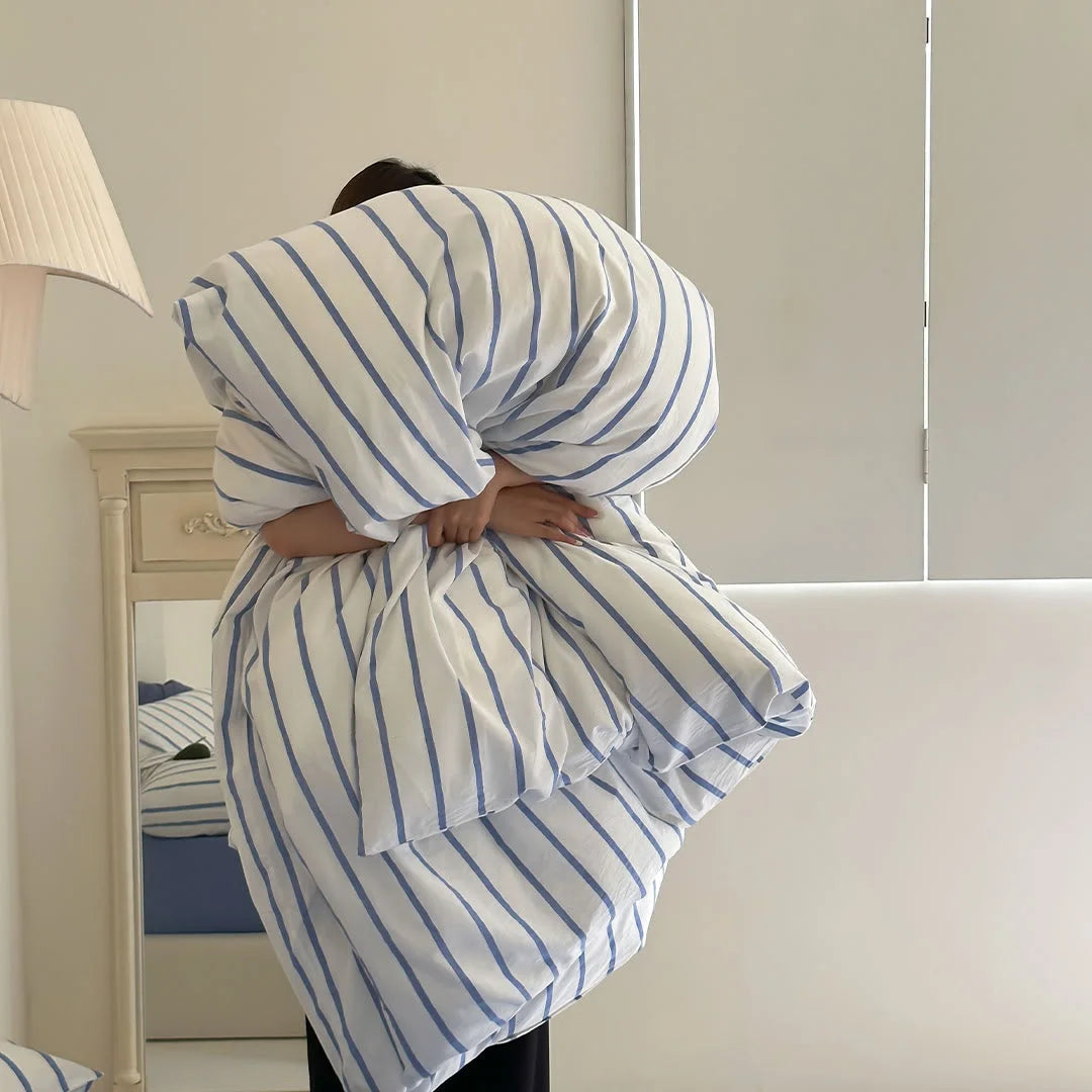 Woman Holding Fluffy Blue Striped Duvet Insert - RoomDen