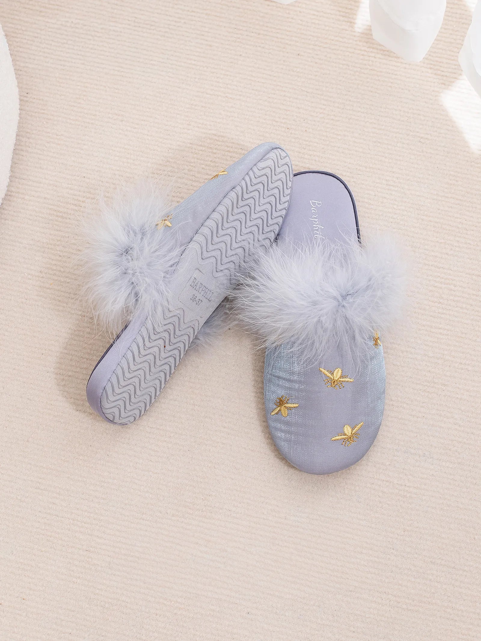 Sole view of Blue slippers showing non-slip texture and branding - RoomDen