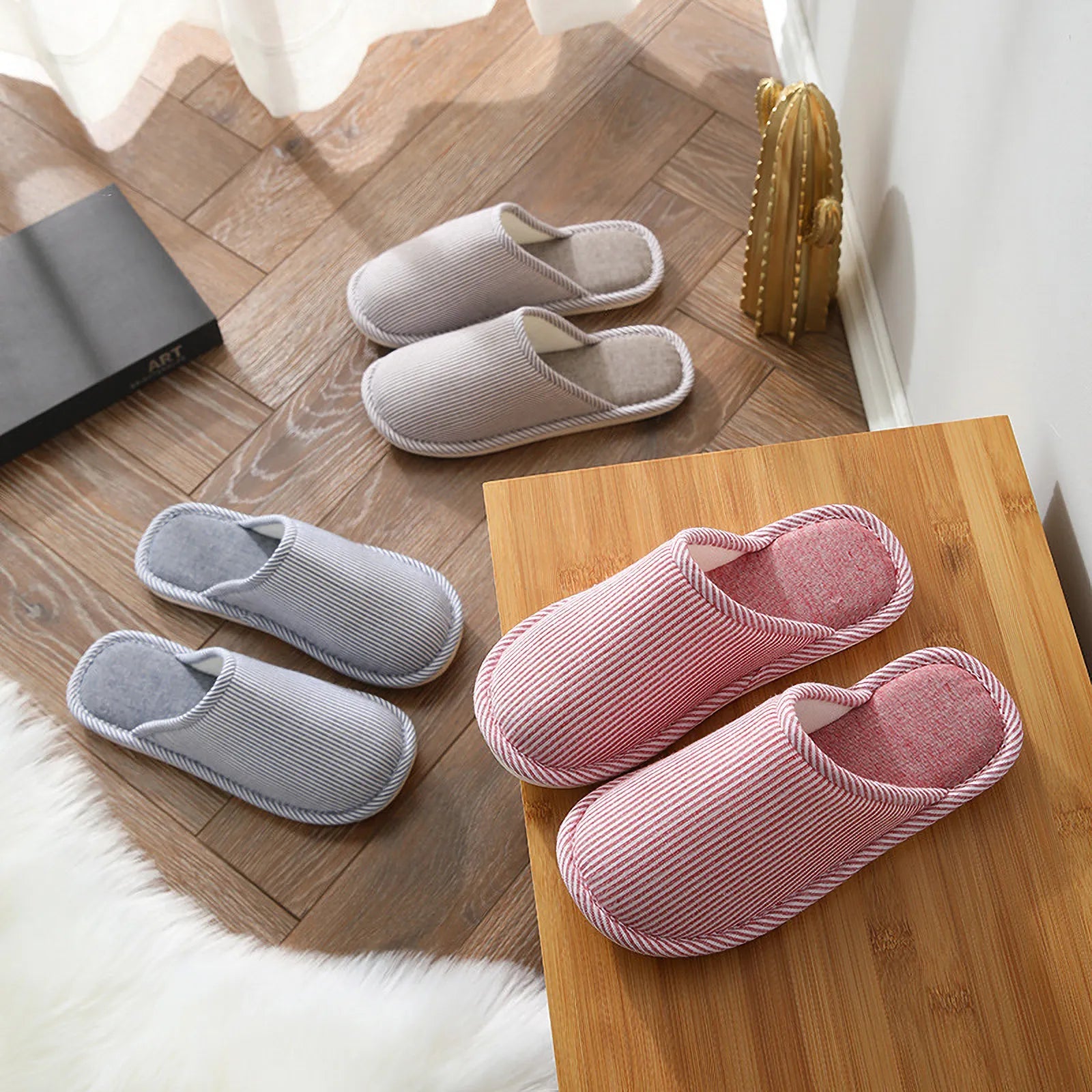 Collection of Grey Blue and Red Striped House Slippers on wooden floor and table - RoomDen
