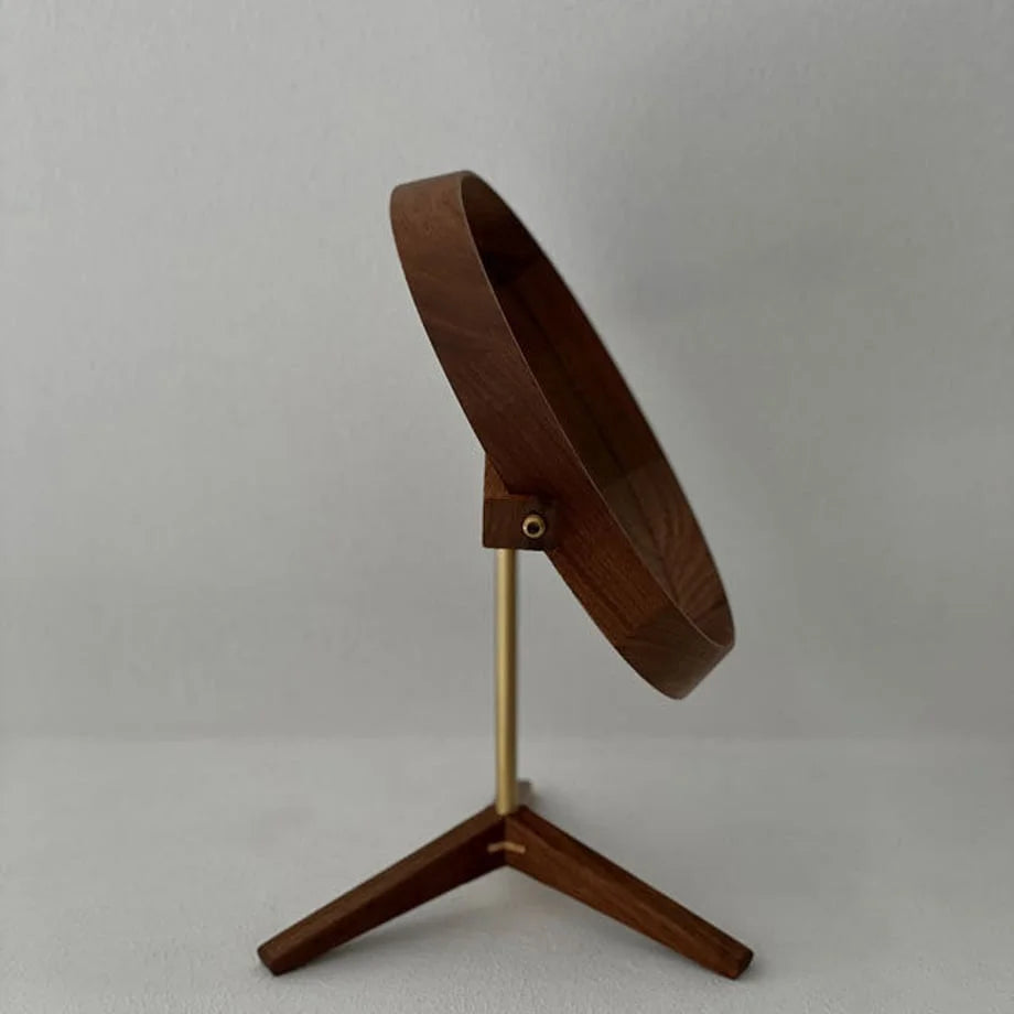 Walnut desktop mirror tilted upwards, demonstrating its adjustable swivel function.
