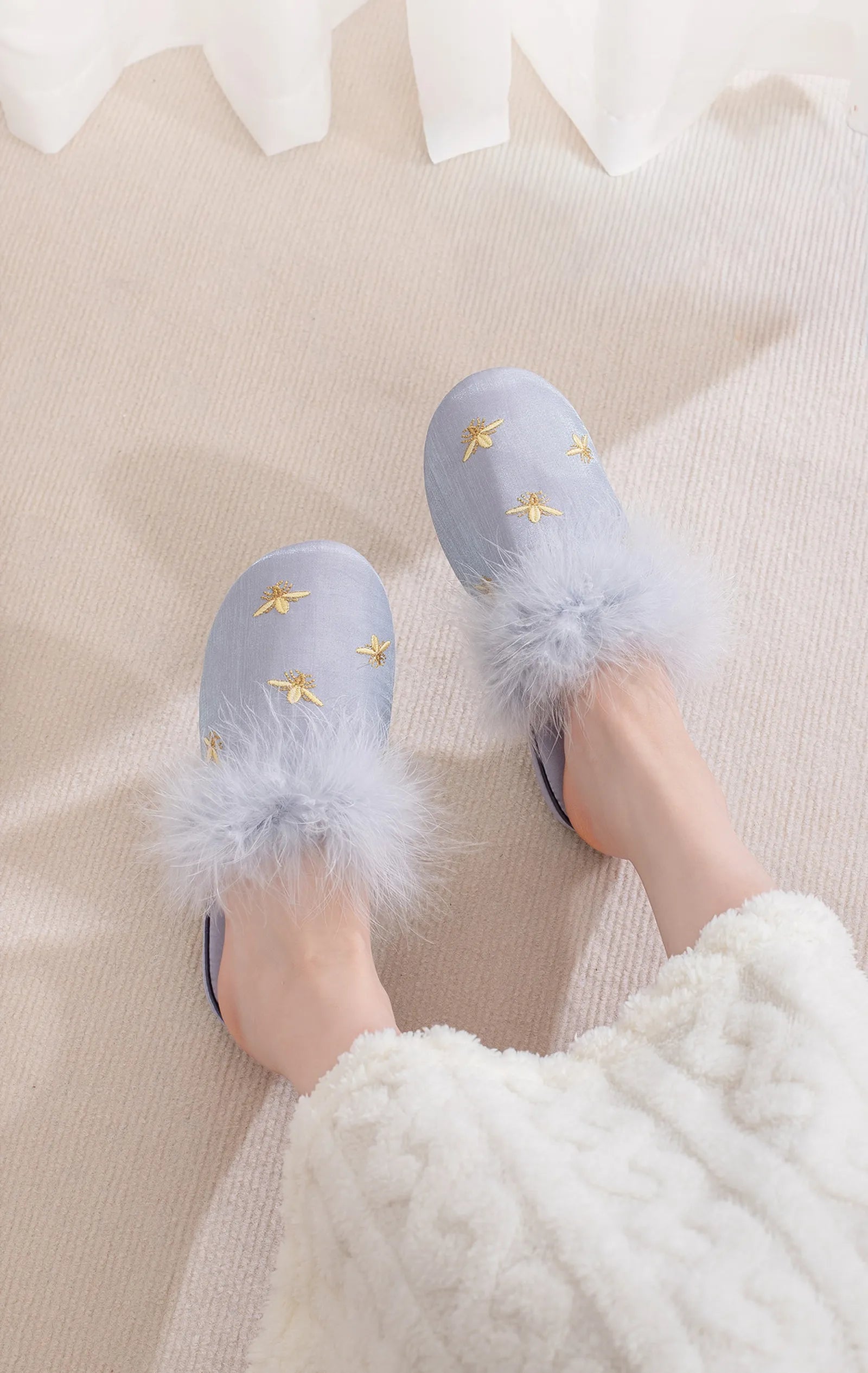 Blue satin house slippers with fluffy trim and gold bee embroidery on legs - RoomDen