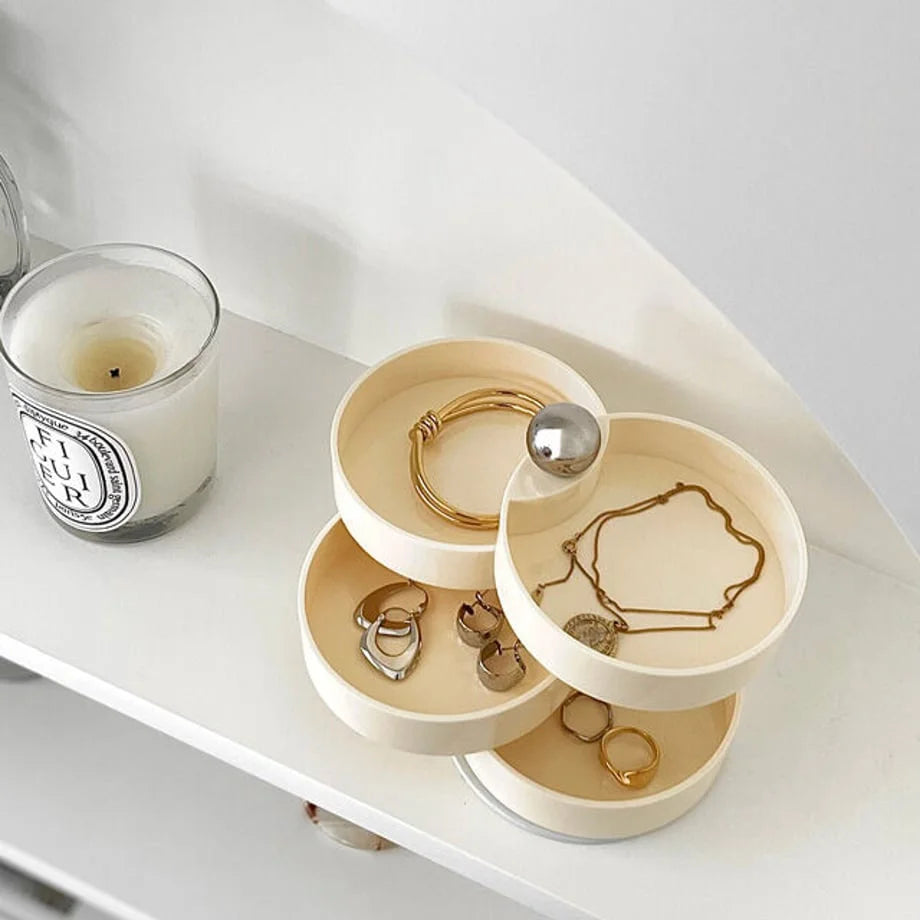 Close-up of the Creamy Beige swivel jewelry organizer, open to display gold and silver rings and bracelets. - RoomDen