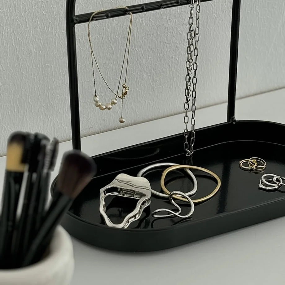 Close-up of the black tray holding various rings and bracelets. - RoomDen