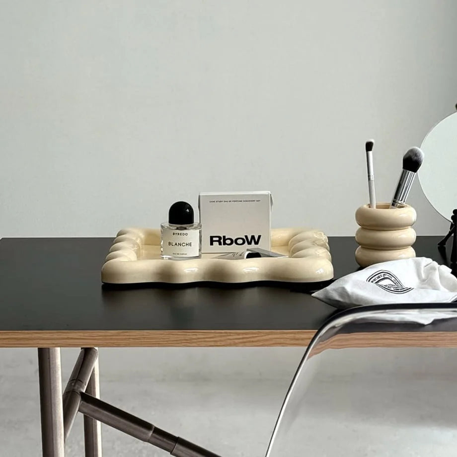 Wide view of the cream wavy trinket tray styled on a modern minimalist desk - RoomDen