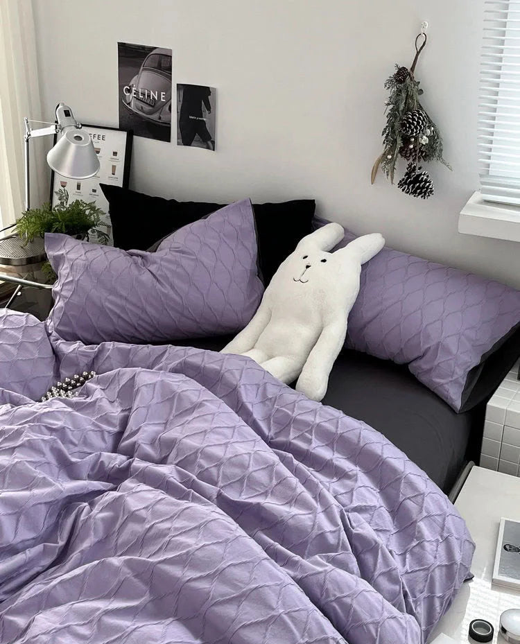 Full view of the bed with the crinkled lavender bedding set, showing the soft, inviting texture. - RoomDen