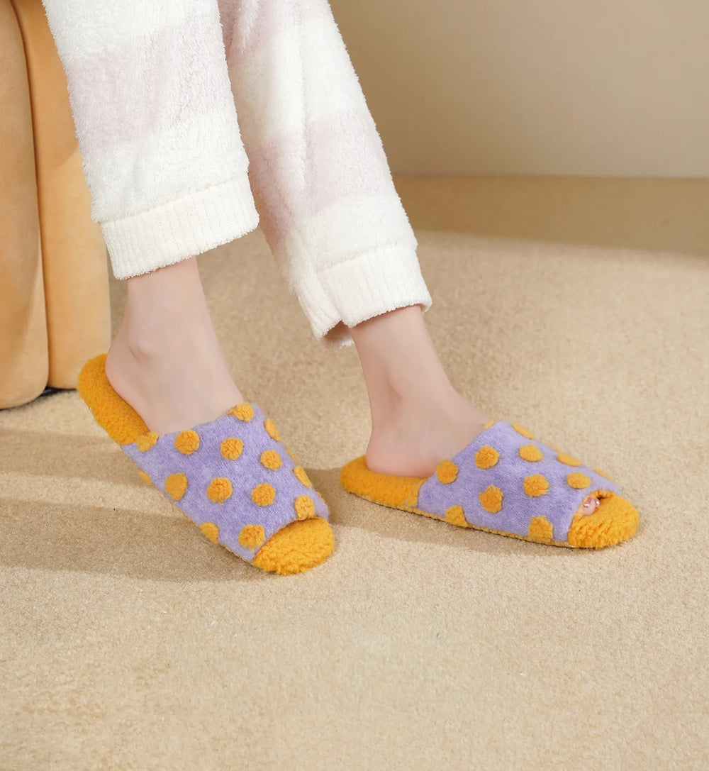 RoomDen Purple Polka Dot Plush House Slippers worn on feet showing fuzzy texture