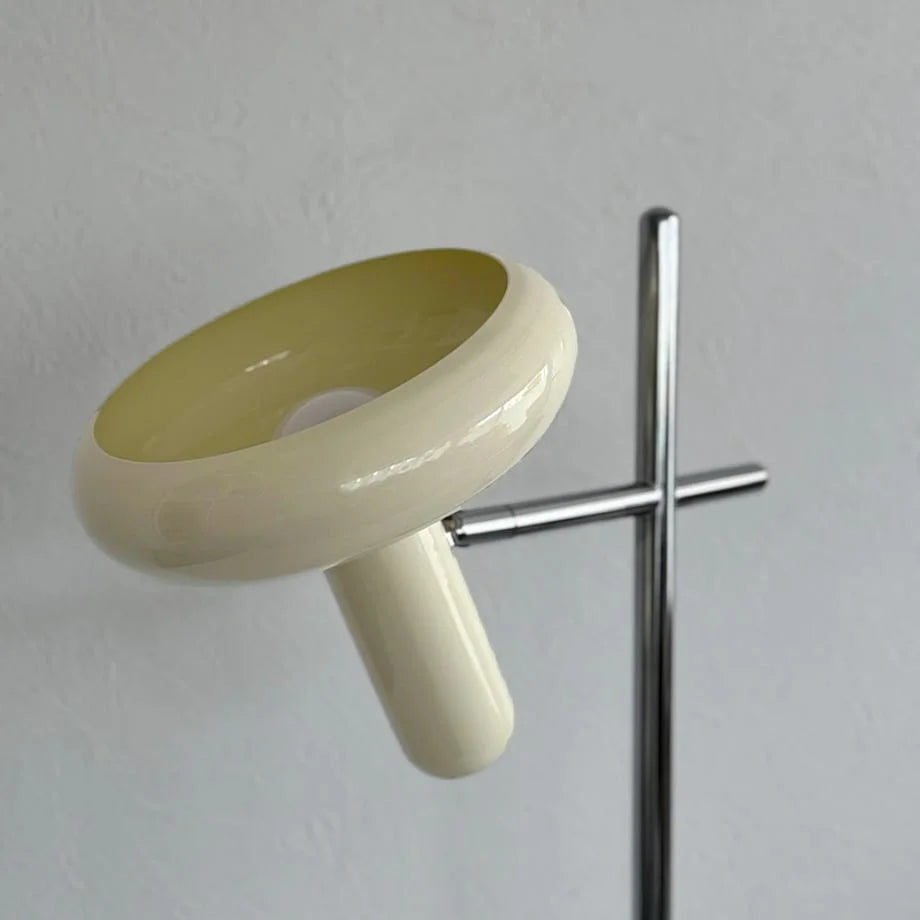 Angled view of the cream-colored mushroom-style lamp shade against a white wall.