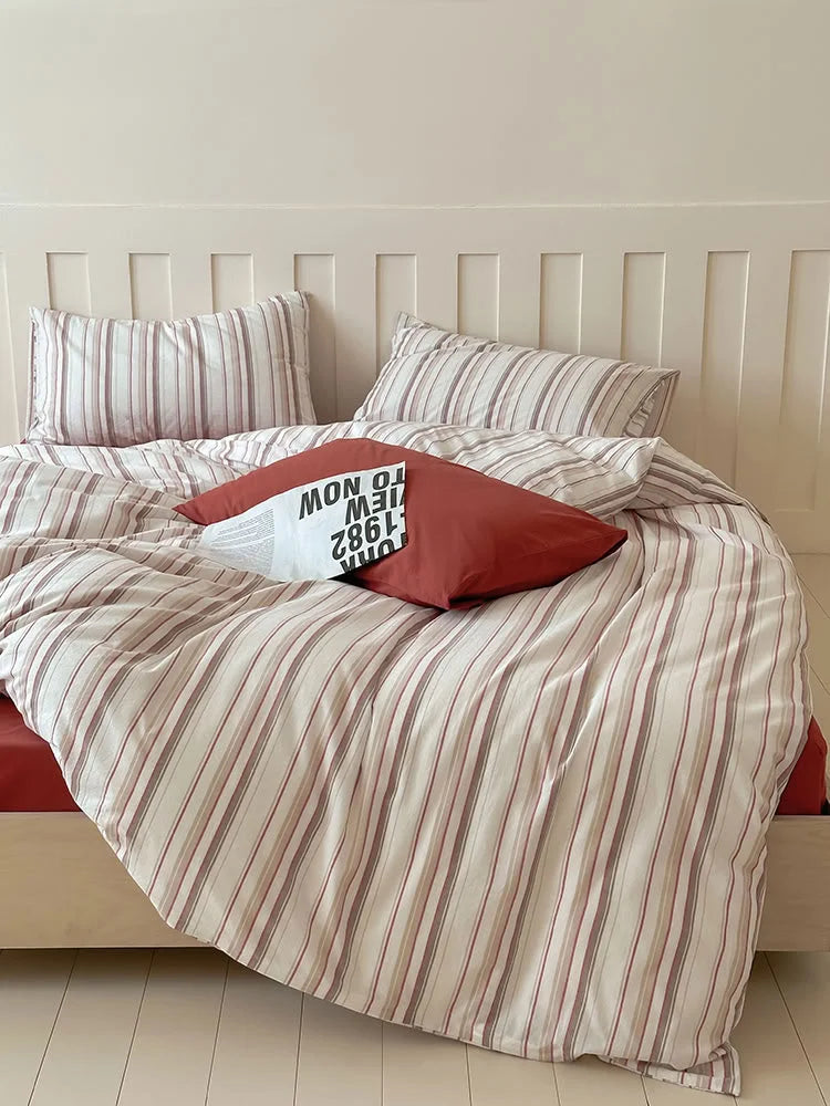 Full view of the Red Striped Washed Cotton Bedding Set on a bed in a bright, minimalist room. - RoomDen
