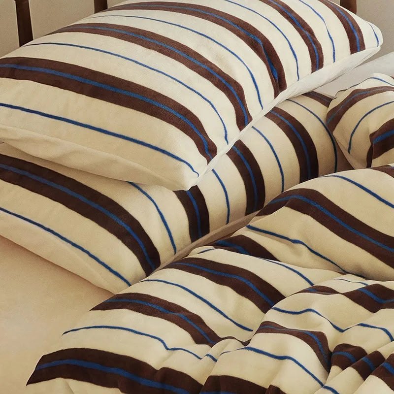 Close-up detail of the cream and brown striped velvet pillowcases, showing the plush fabric - RoomDen.