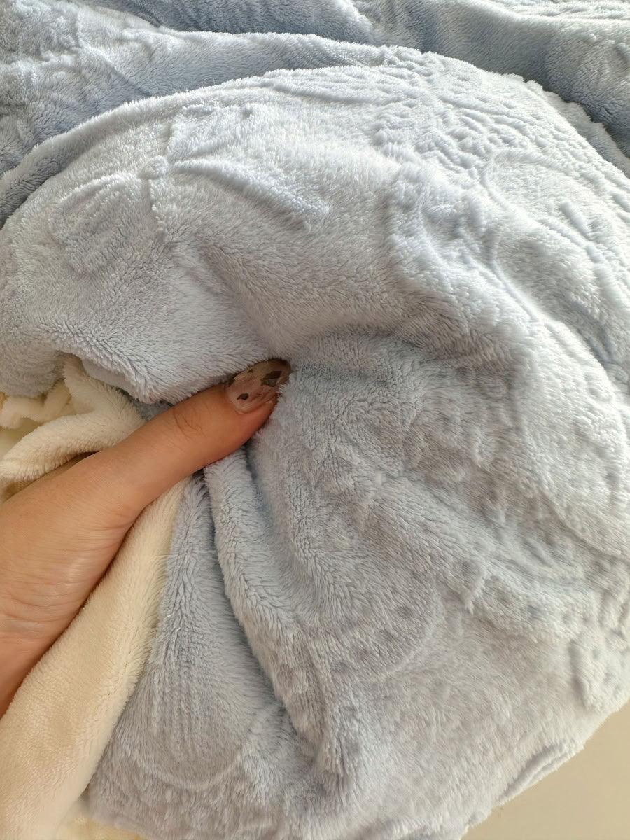 Close-up of light blue flannel fleece fabric showing embossed bow and floral design - RoomDen