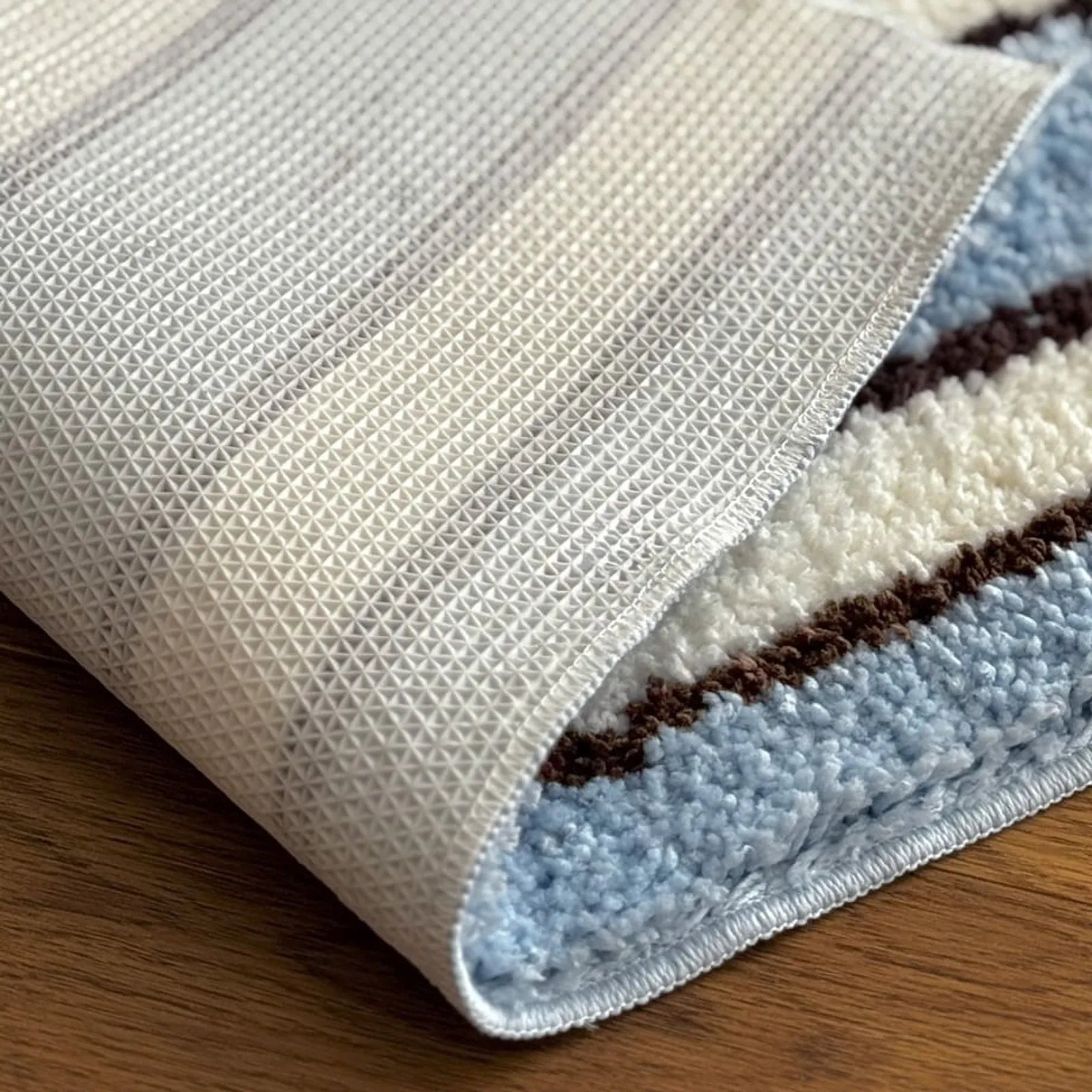 Detail shot of non-slip TPR backing on the blue and white rug - RoomDen
