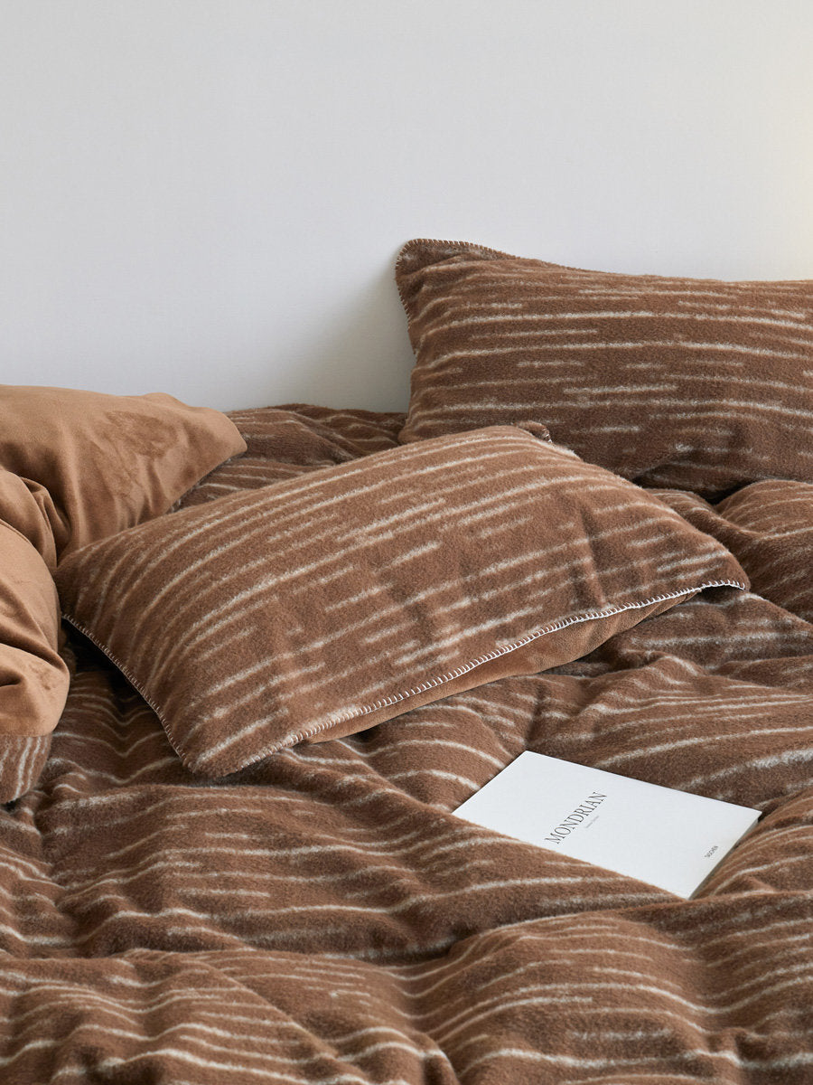 Warm brown flannel fleece bedding set with cream brushstroke stripes and soft folded duvet - RoomDen