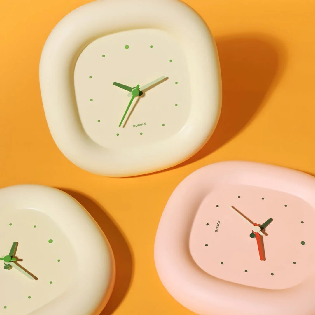 Three Puffy Bubble Table Clocks in Creamy Beige and Pastel Pink on a bright orange background - RoomDen