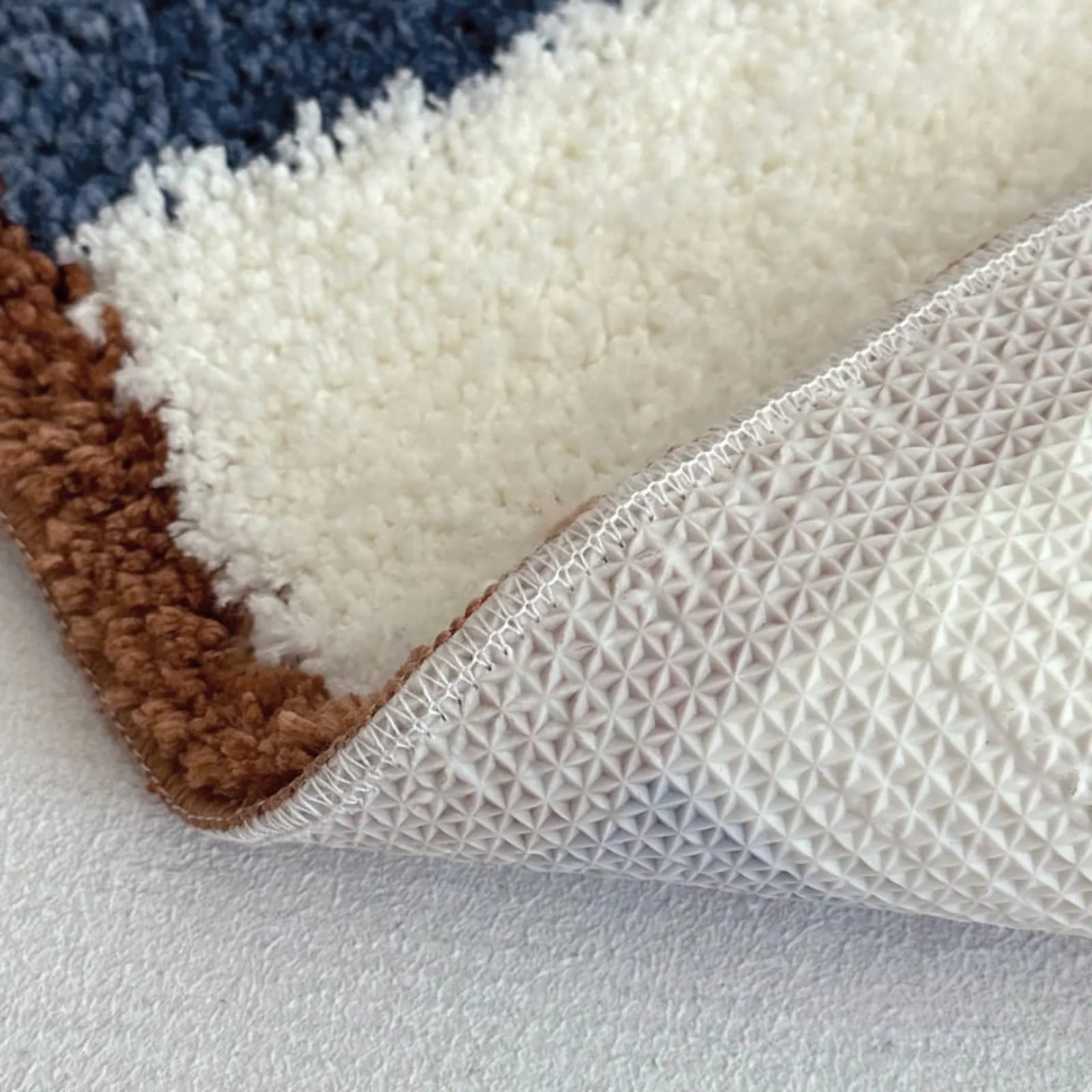 Detail shot showing anti-slip backing and thick polyester fibers - RoomDen