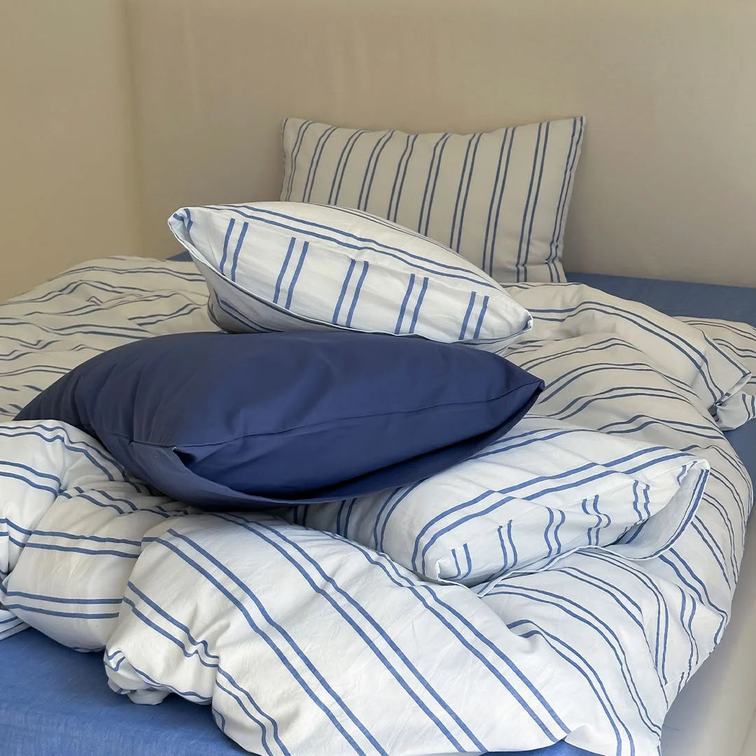 Close up of Blue Pinstripe Pattern and Solid Blue Pillow - Texture Detail