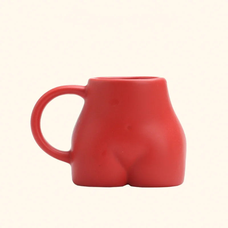 The red sculptural body ceramic mug with a matte finish on a white background. - RoomDen