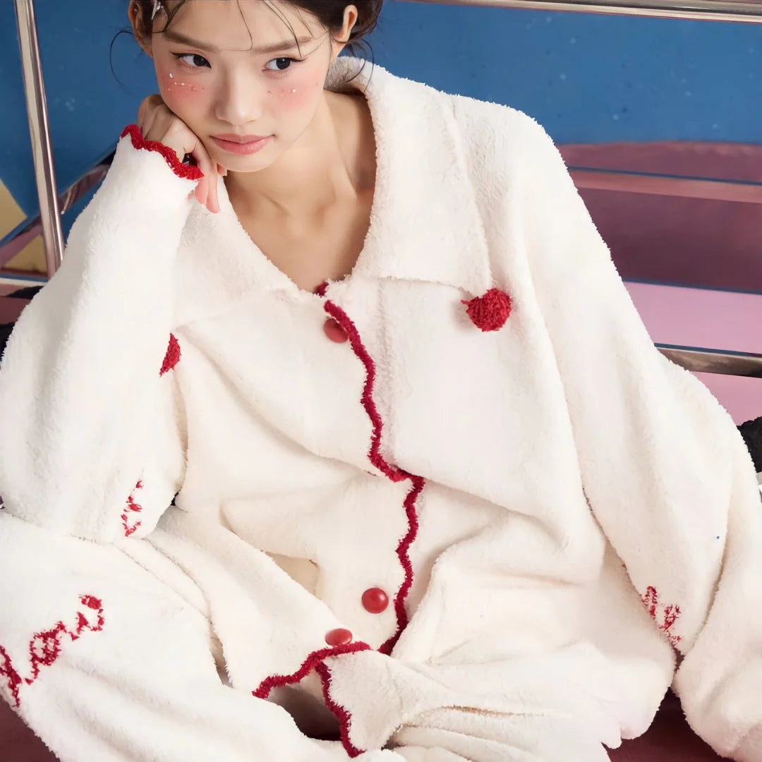 A detailed shot of the soft texture and button-up front of the Cream White fleece pajama top.