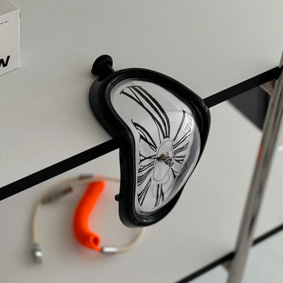 Angled detail shot of the black melting clock showing its warped form.
