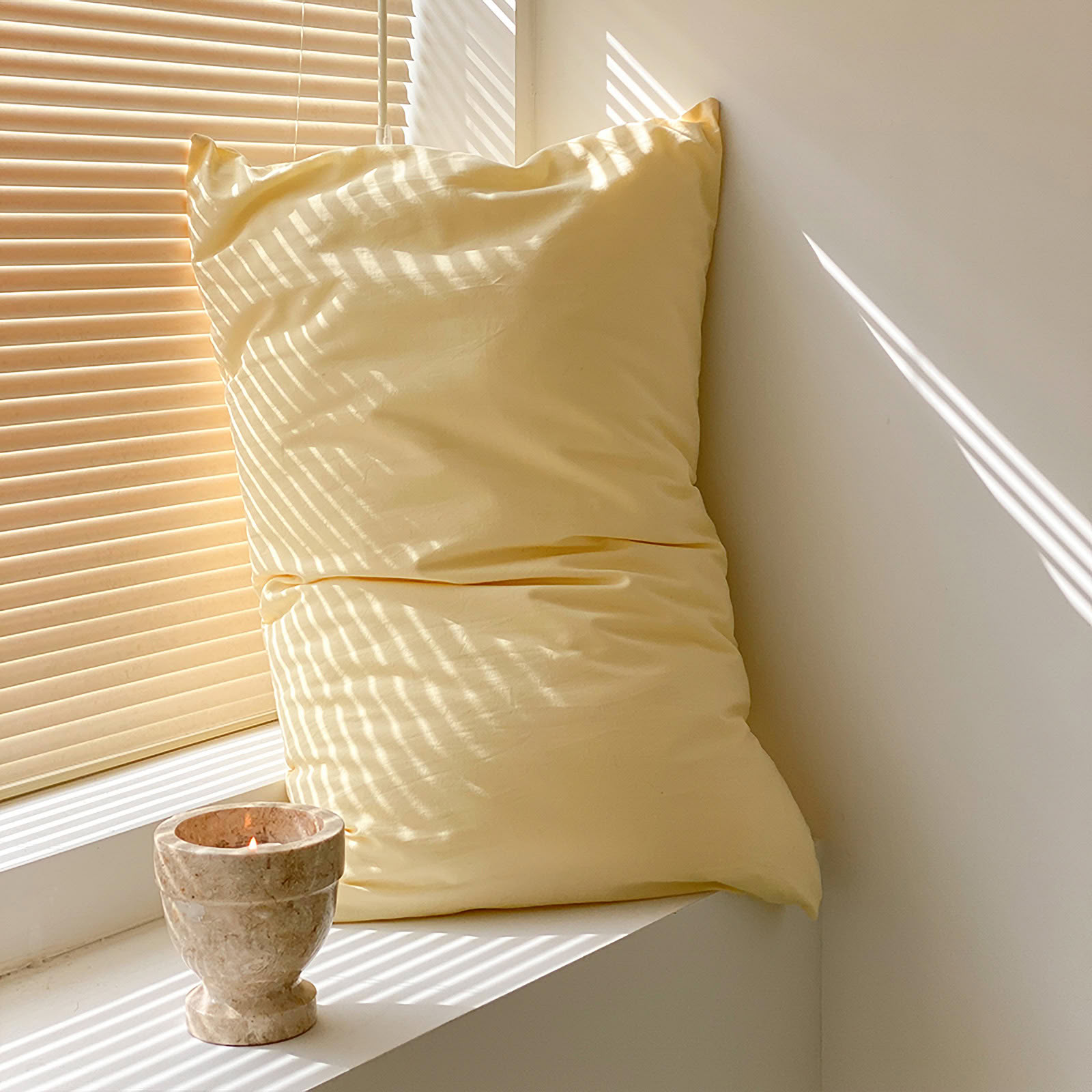 Soft washed cotton solid pillowcase in a minimalist cozy bedroom – RoomDen