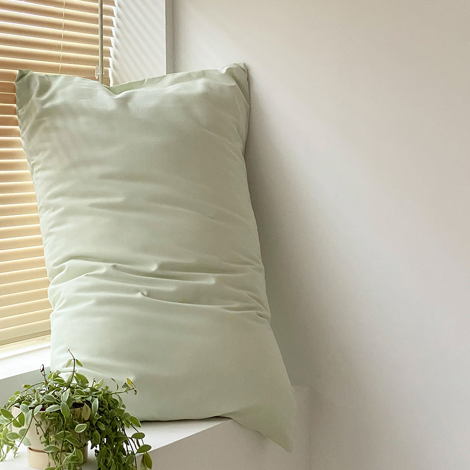 Soft washed cotton solid pillowcase in a minimalist cozy bedroom – RoomDen