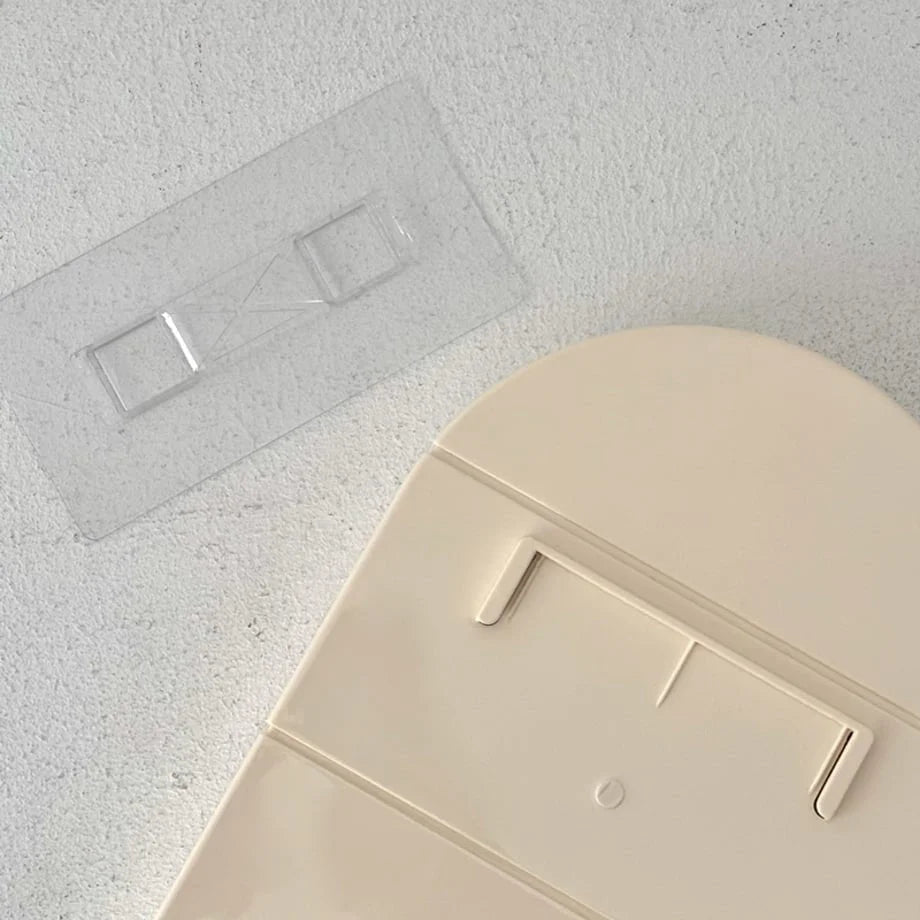 Detail shot of the transparent adhesive wall mount for the damage-free shelf installation - RoomDen.