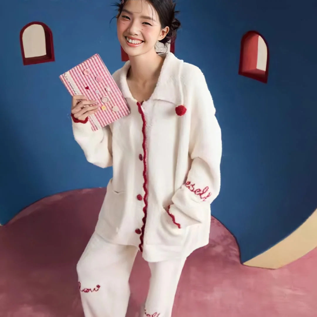 A cheerful model holding a striped clutch while wearing the soft fleece pajama set in Cream White.