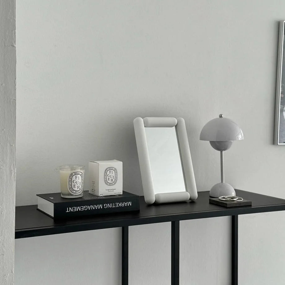 Lifestyle scene of the white rounded frame mirror on a console table. - RoomDen