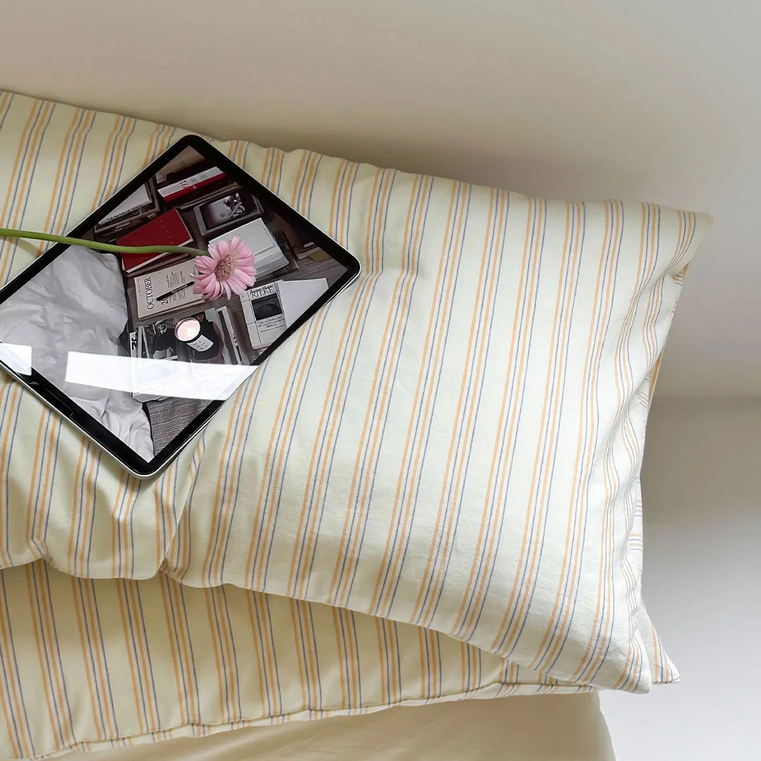 Aesthetic Flat Lay of Yellow Striped Pillow with Tablet and Flowers - RoomDen