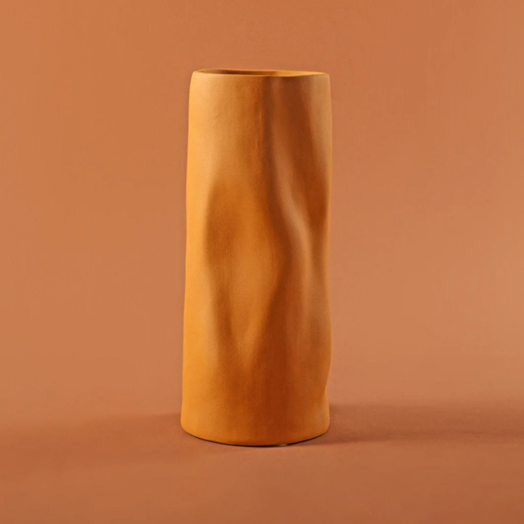 Main image of the Ruched Frosted Ceramic Vase in Mustard color against a matching background - RoomDen.