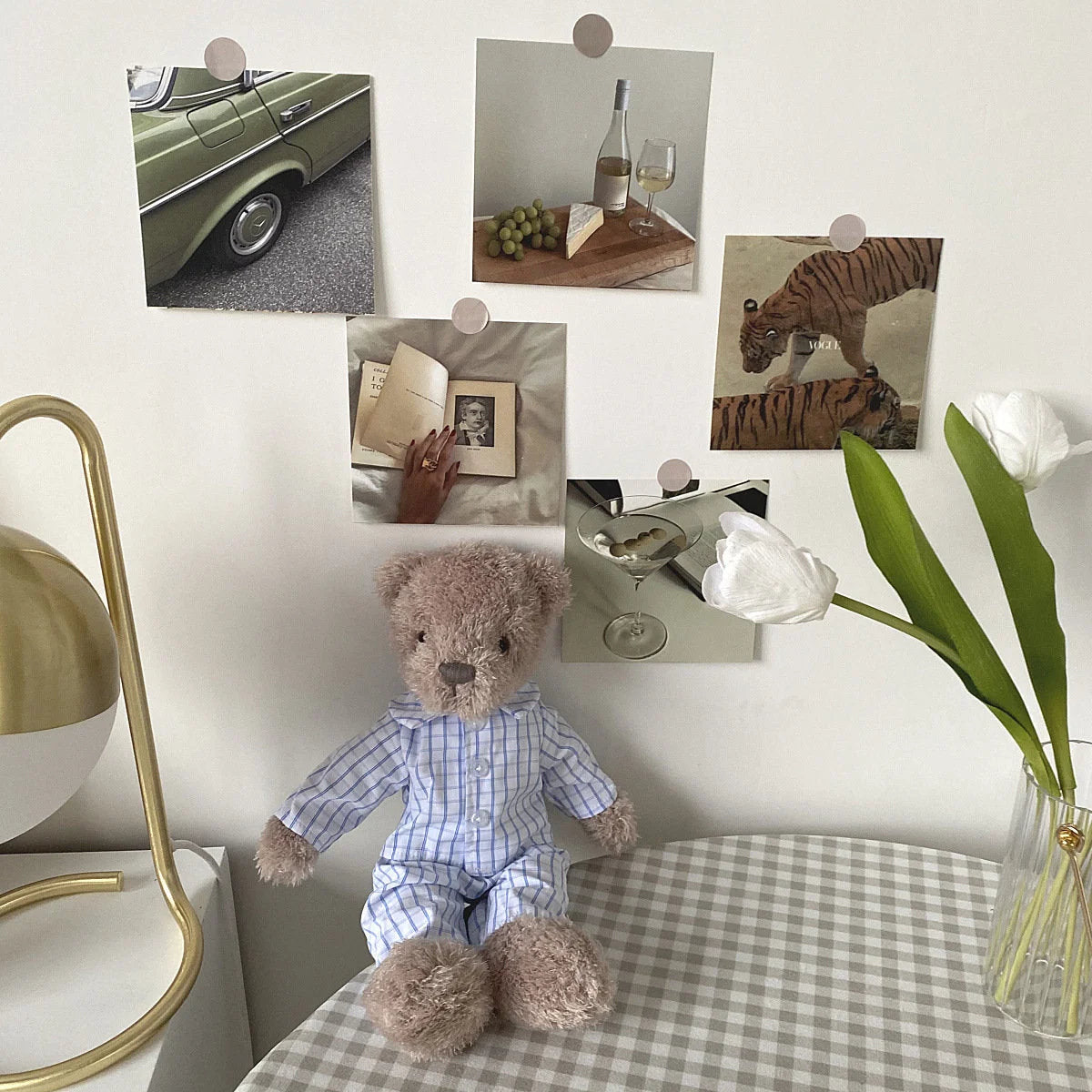 Vintage-inspired prints from the Wall Collage Kit creating a cozy bedroom corner with a teddy bear and lamp - RoomDen
