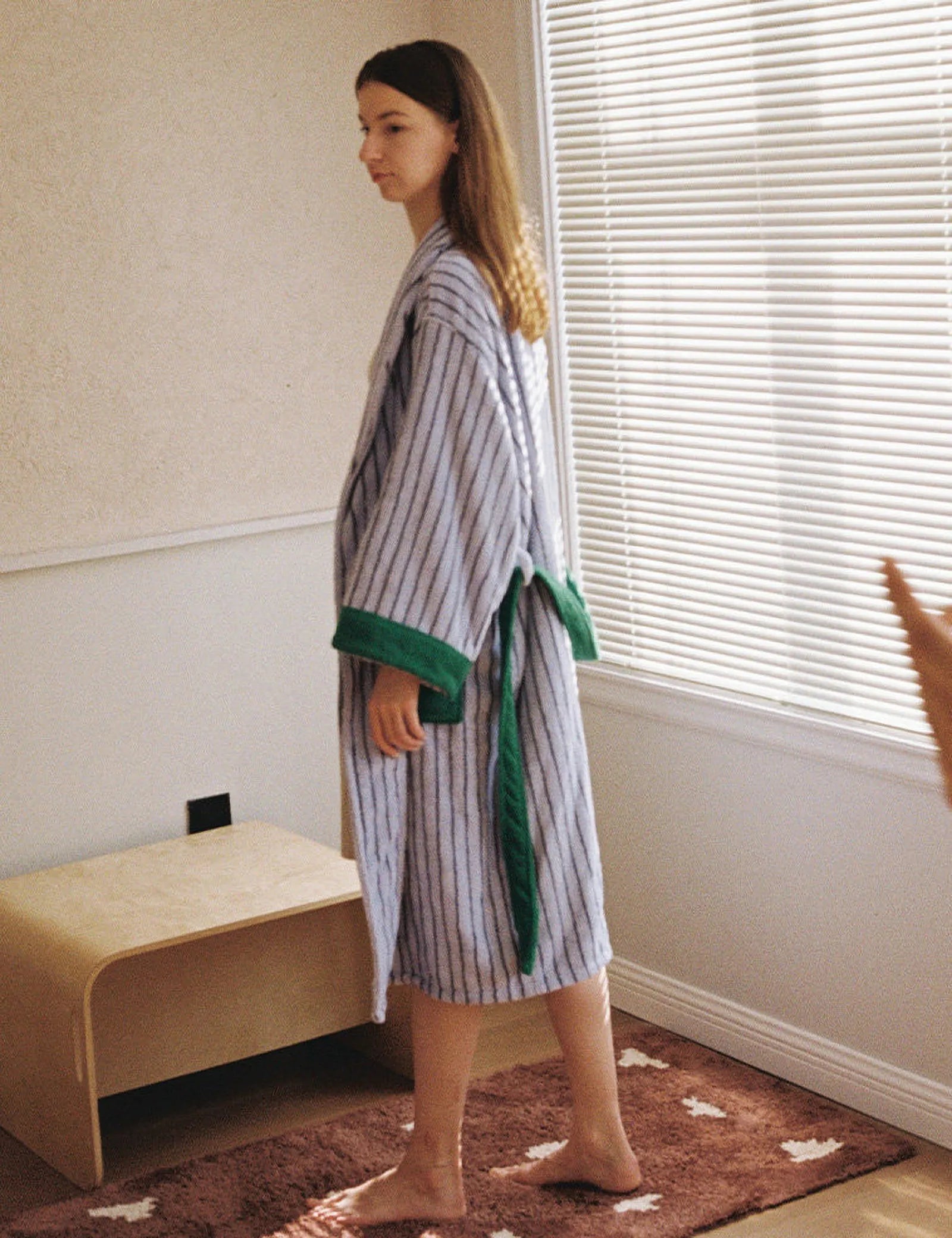 Side view of the blue striped robe showing the length and green trim details.