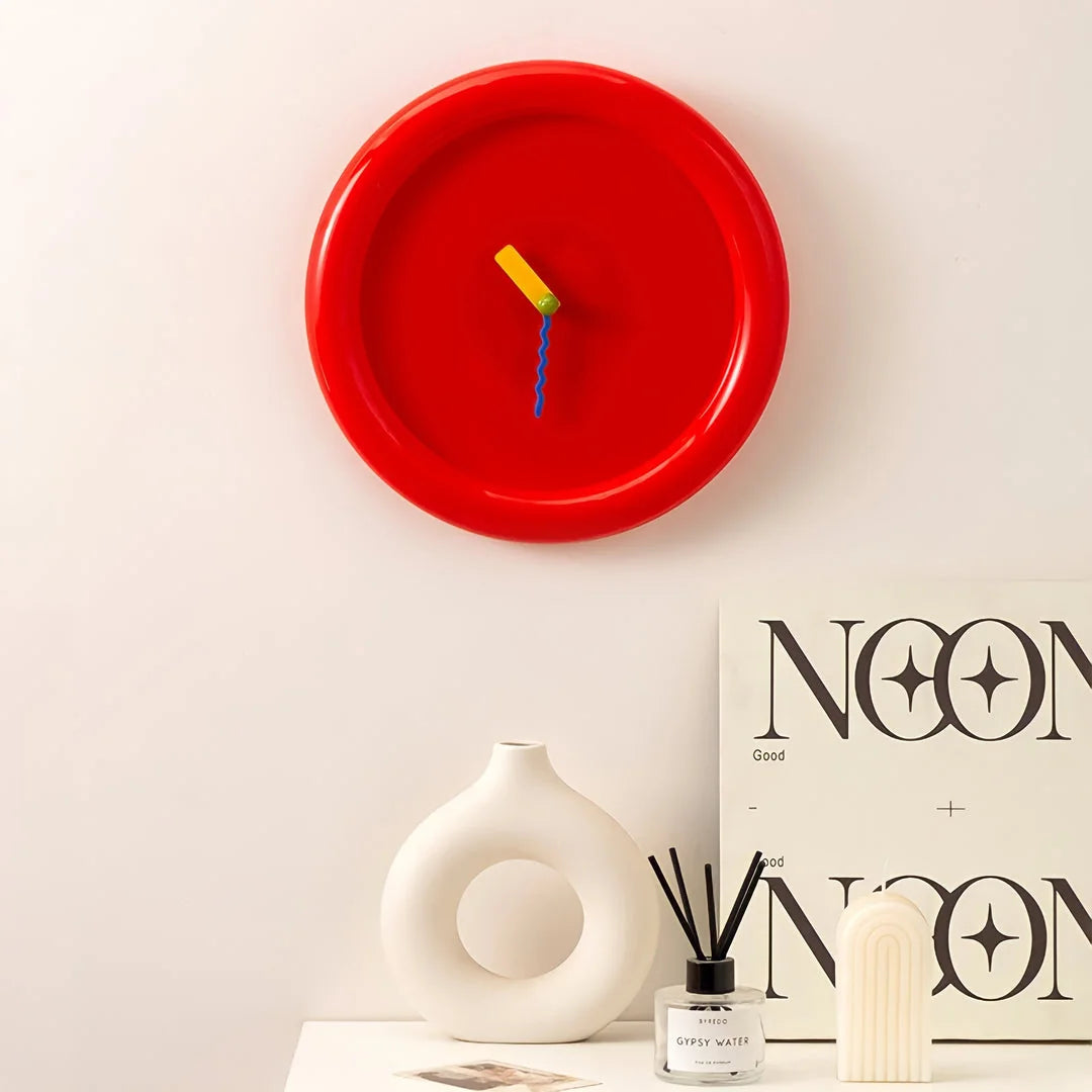 Cherry Red Chunky Frame Wall Clock hanging on a white wall above a vase - RoomDen