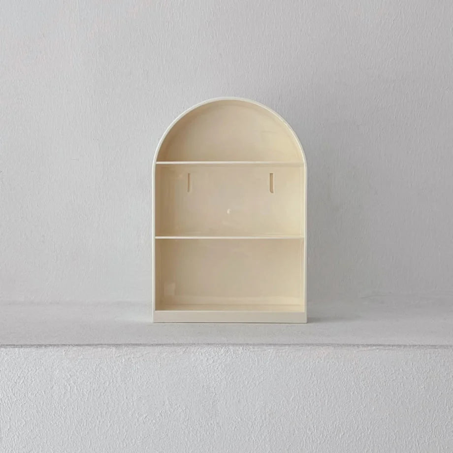Front view of the empty cream arched wall shelf showing the two tiers and mounting slots - RoomDen.